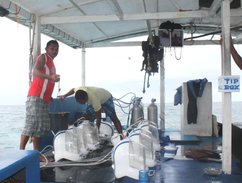 Julius, our boatman and the equipment for Helmet Diving